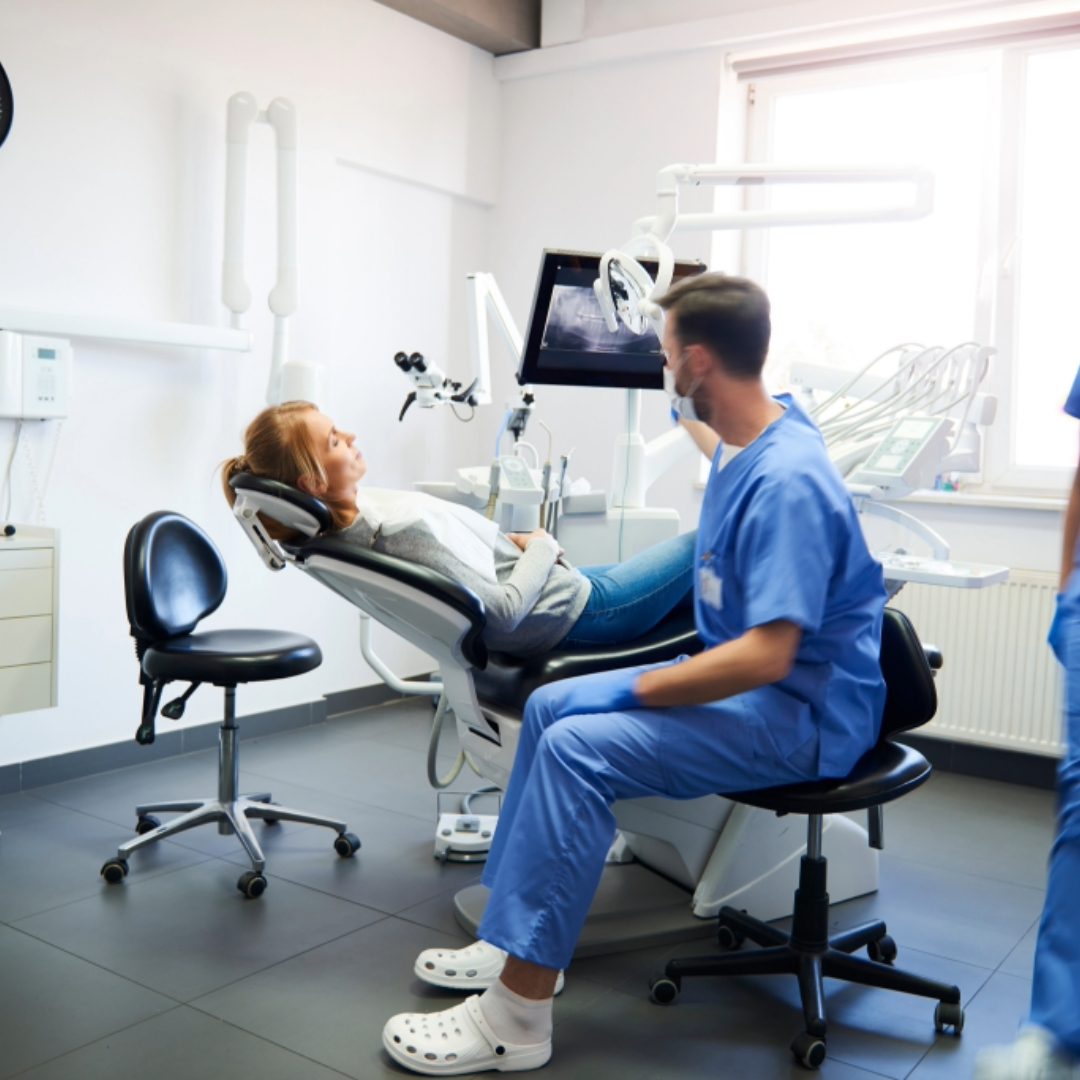 Dental professional with a patient in a modern clinic—schedule private CPR, First Aid, and BLS certification classes in Butte County for dental offices, healthcare teams, and medical staff.